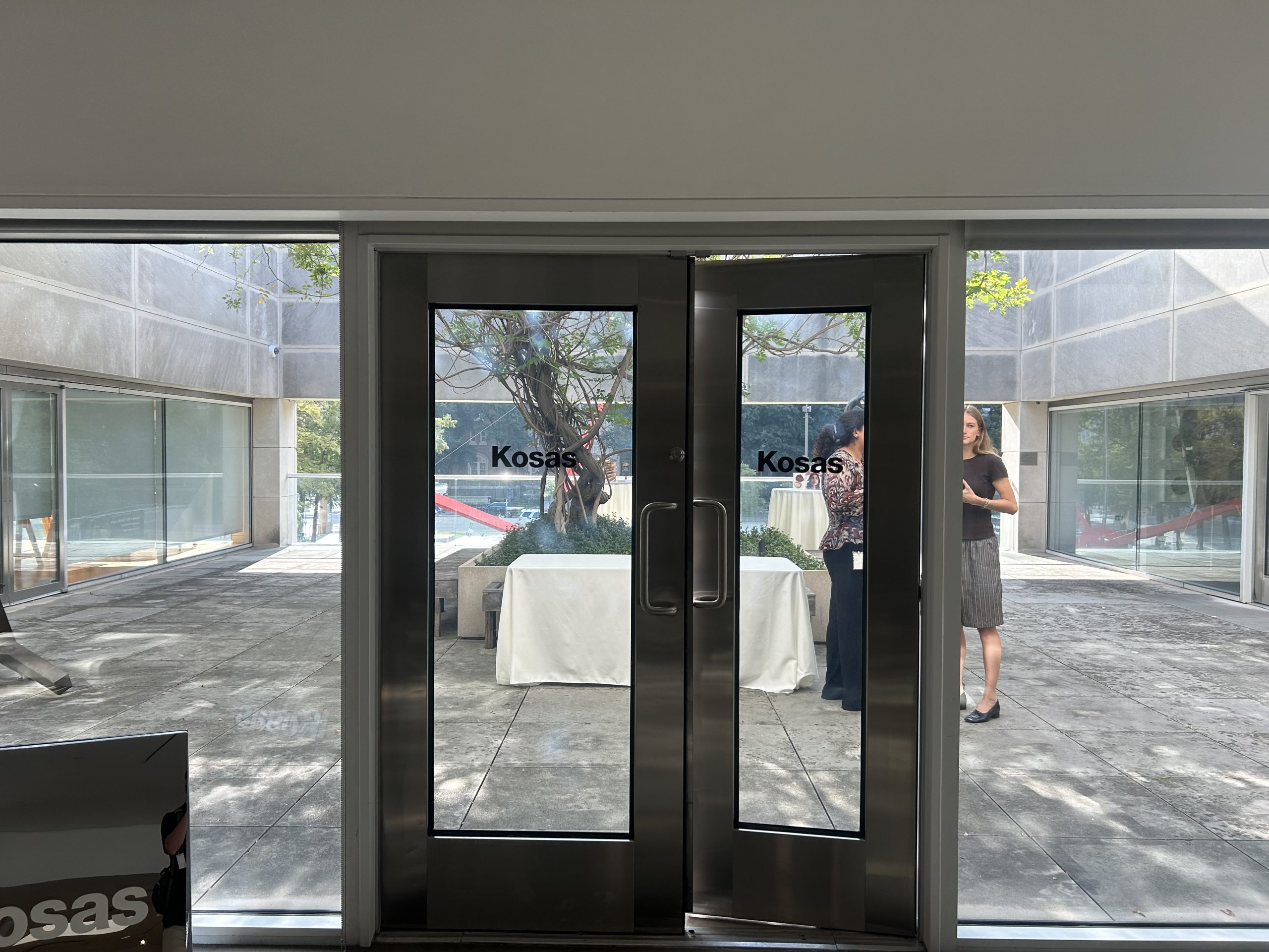 Black Kosas vinyl logos applied to glass doors opening onto the event terrace.