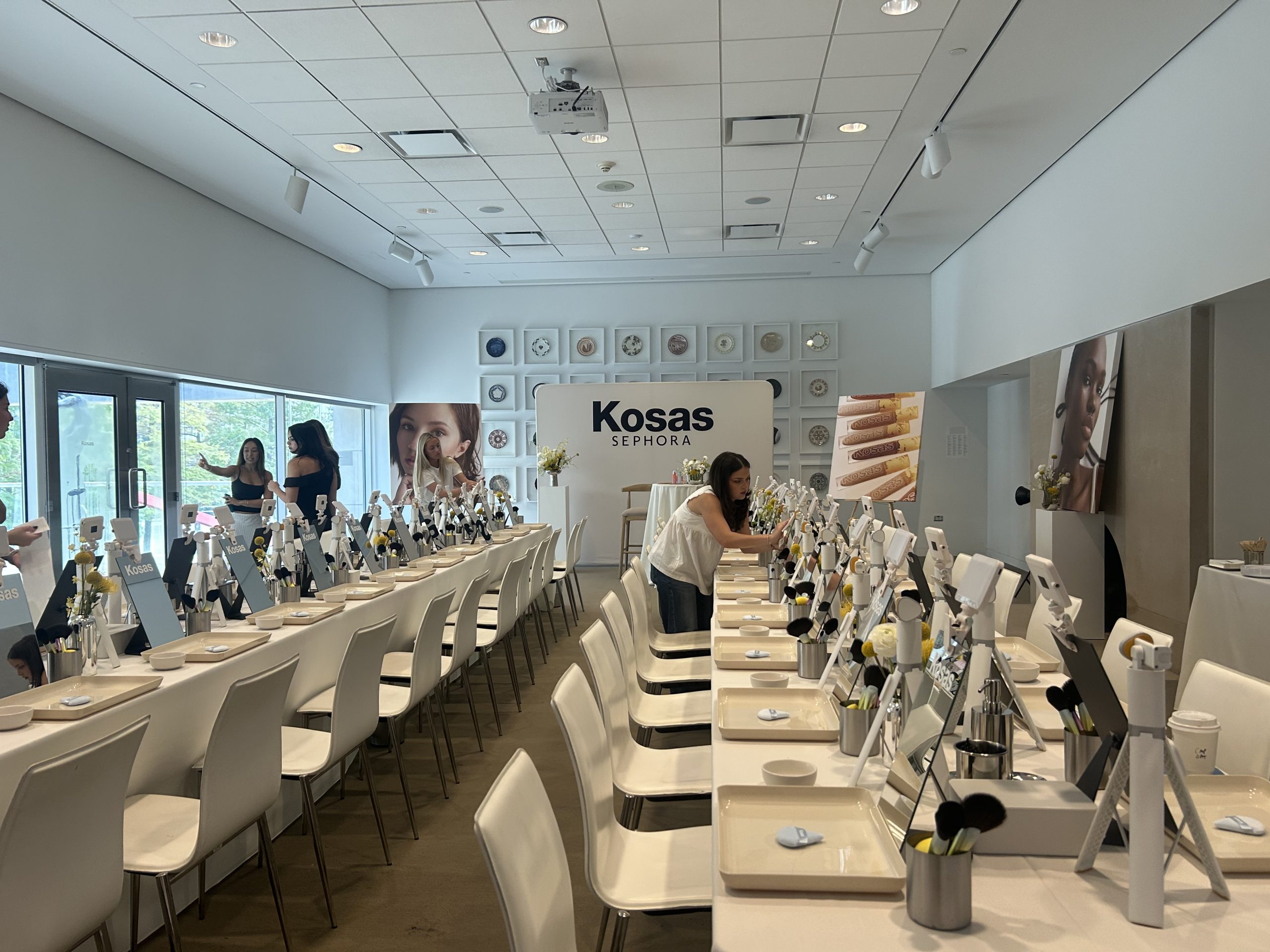 Rows of Kosas-branded makeup mirrors and individual workstations at the masterclass event.